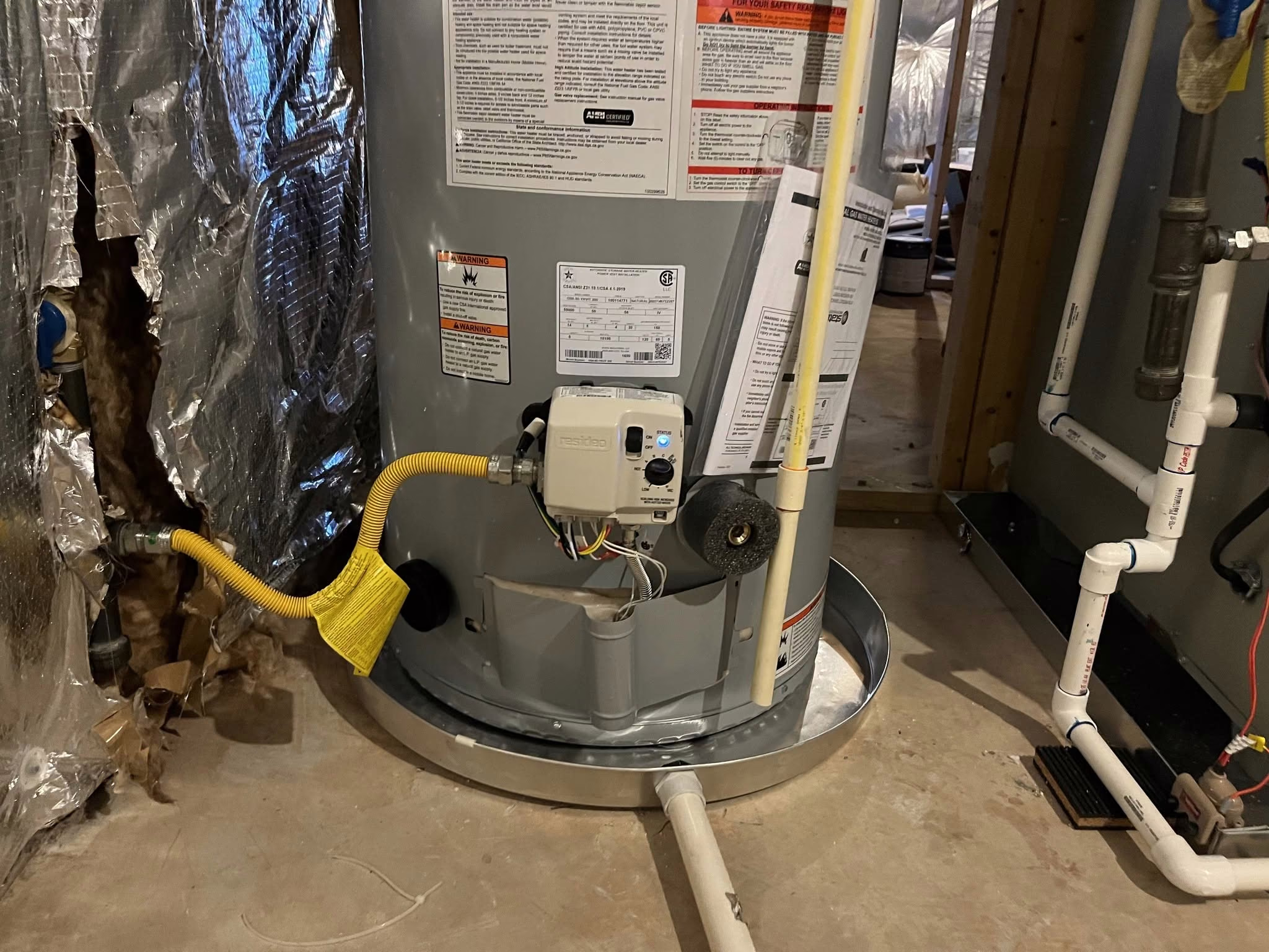 Gas water heater installed with a drain pan